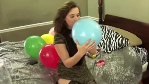 Blowing balloons and popping them while chewing bubblegum